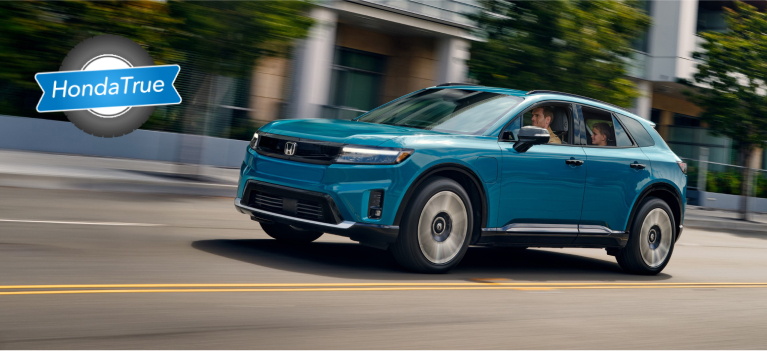 Honda Certified Prologue driving through a city Honda Certified Prologue driving through a city