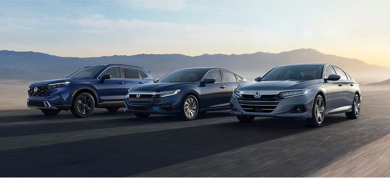 Three Honda Vehicles lined up with mountains in background