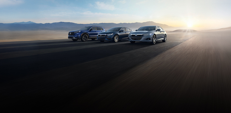 2022 Honda CR-V, Insight and Accord front profile driving on a desert highway at sunset.